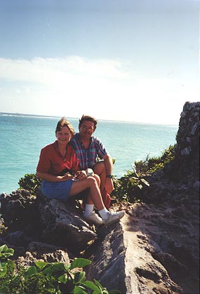 Liz and Dennis sitting with the sea behind them.